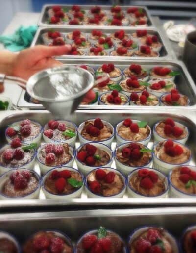 Prepared mousse dessert servings with strawberry garnish.