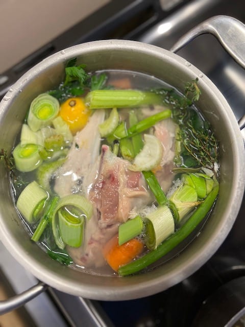 Pot of chicken and vegetables on stove