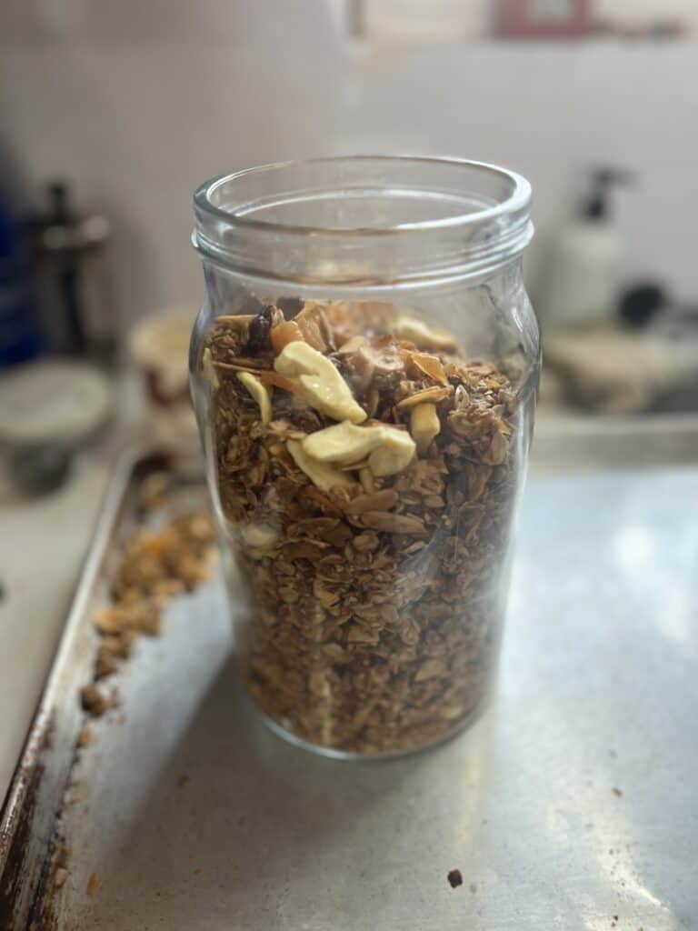 Jar of granola on a baking tray